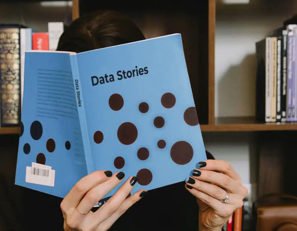 Woman reading Data Stories book on how to use data to tell great stories