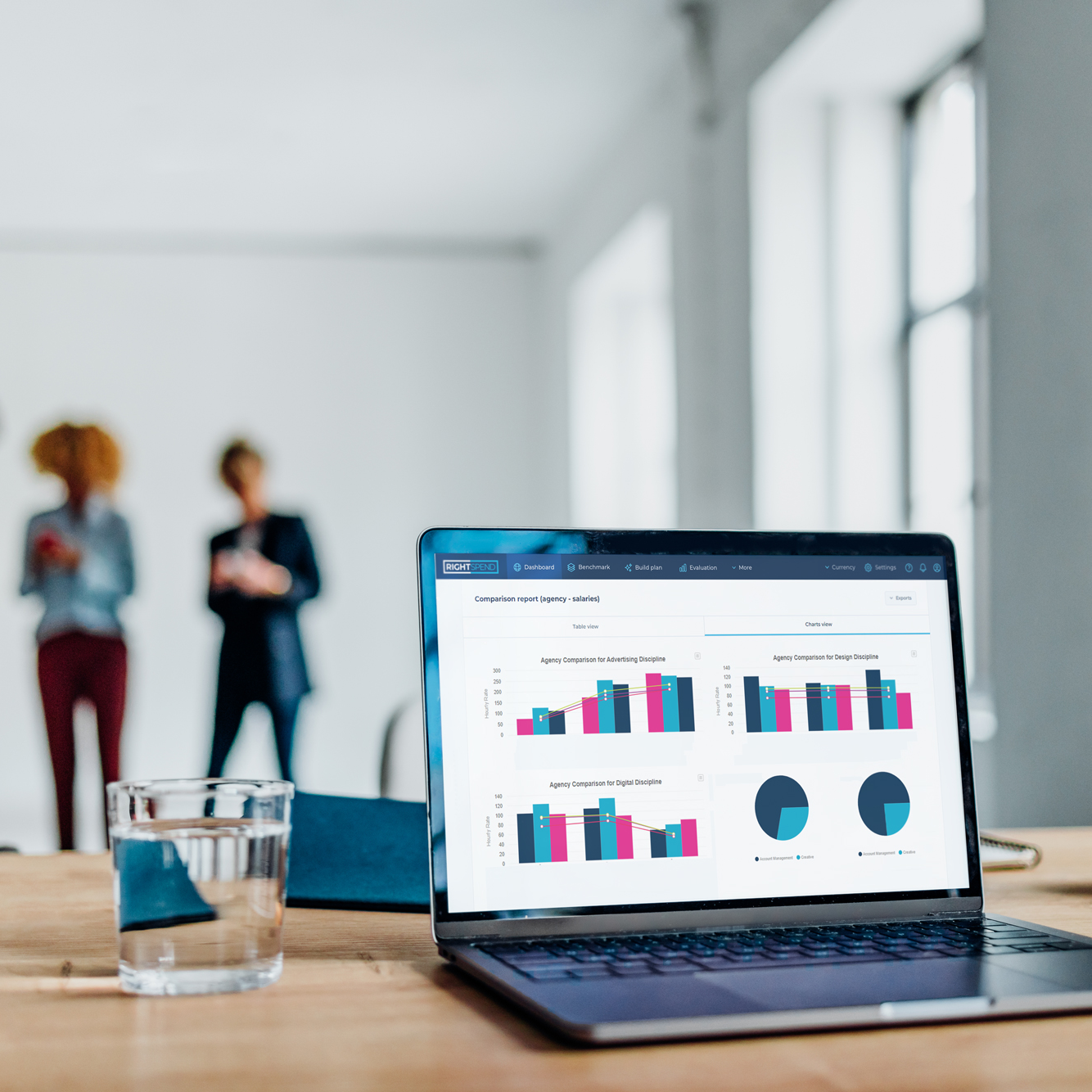 RightSpend Marketing PRocurement Benchmarking tool on laptop with team in background-solutions