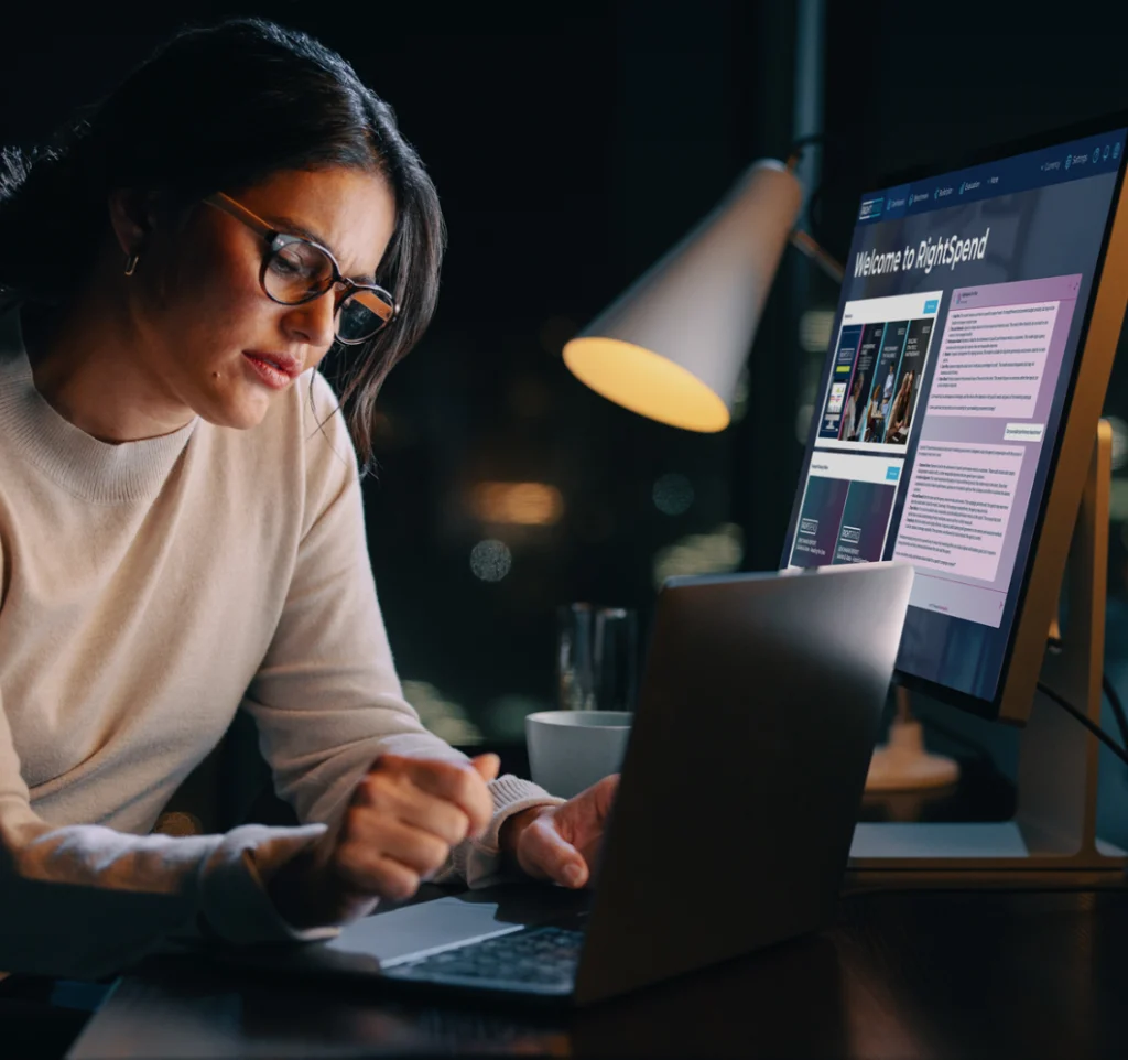 Marketing Procurement Manager with RightSpend open on two screens to help her with a Marketing Budget Review